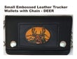 A small black leather trucker hat with a black strap and a circular embroidered patch featuring a tiger head and the text 'DEER'.